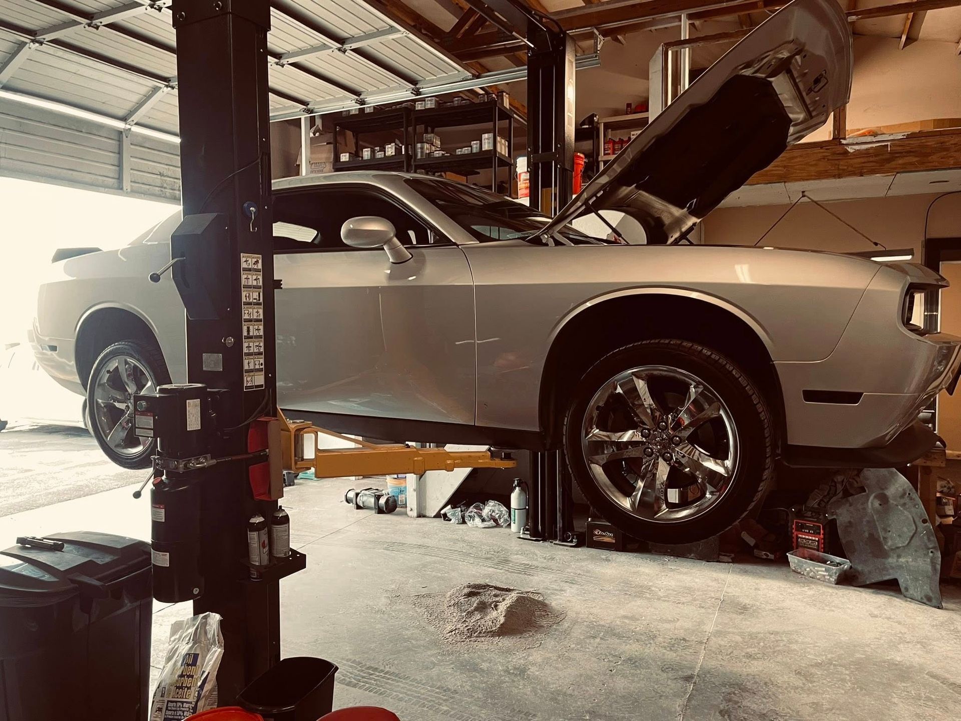 Car On Lift During Professional Auto Repair Service | Frontier Automotive