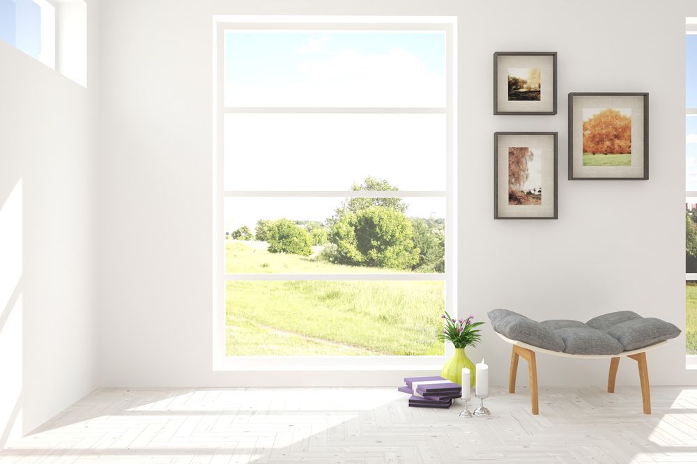 A Living Room with A Chair and A Window with A View of A Field — The Framer In Taree, NSW