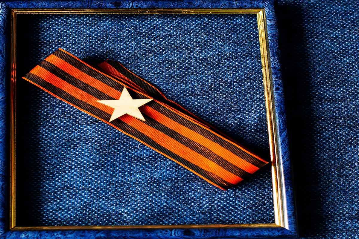 An Orange and Black Ribbon with A White Star on It — The Framer In Taree, NSW