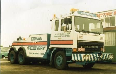 a tow truck is parked in front of a building .