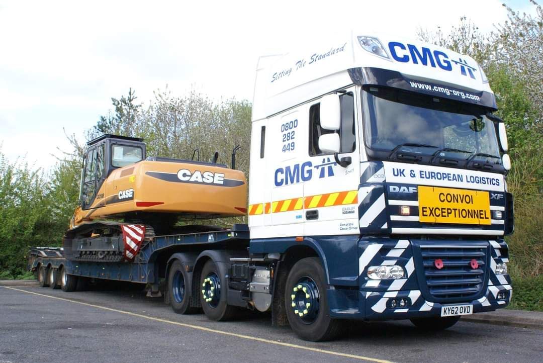 a low loader with a case excavator on the back of it