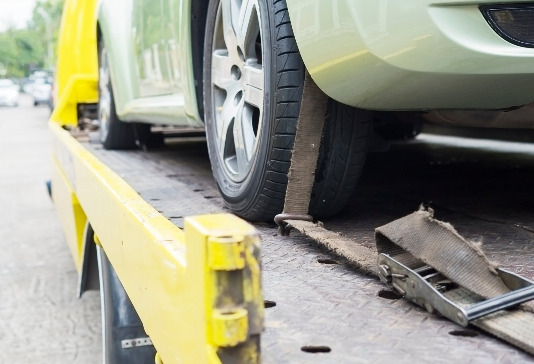 A car is being towed by a tow truck.