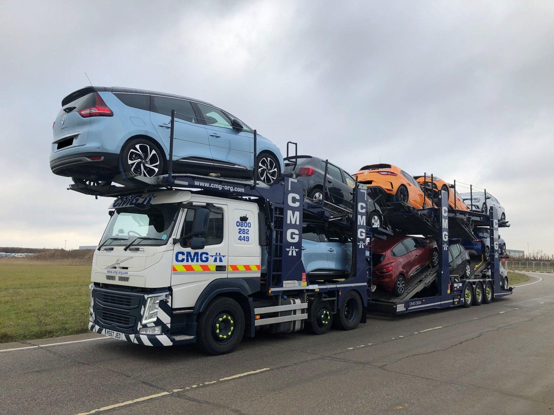 A truck is carrying a bunch of cars on top of it.