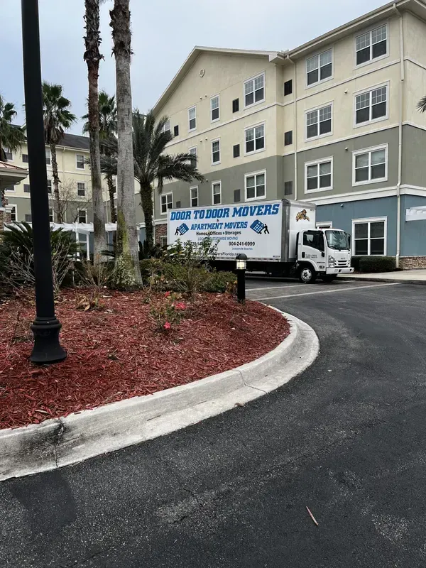 Moving truck parked at an apartment building, the company name Ready To Load Movers is visible.