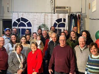 A group of business people are posing for a picture together