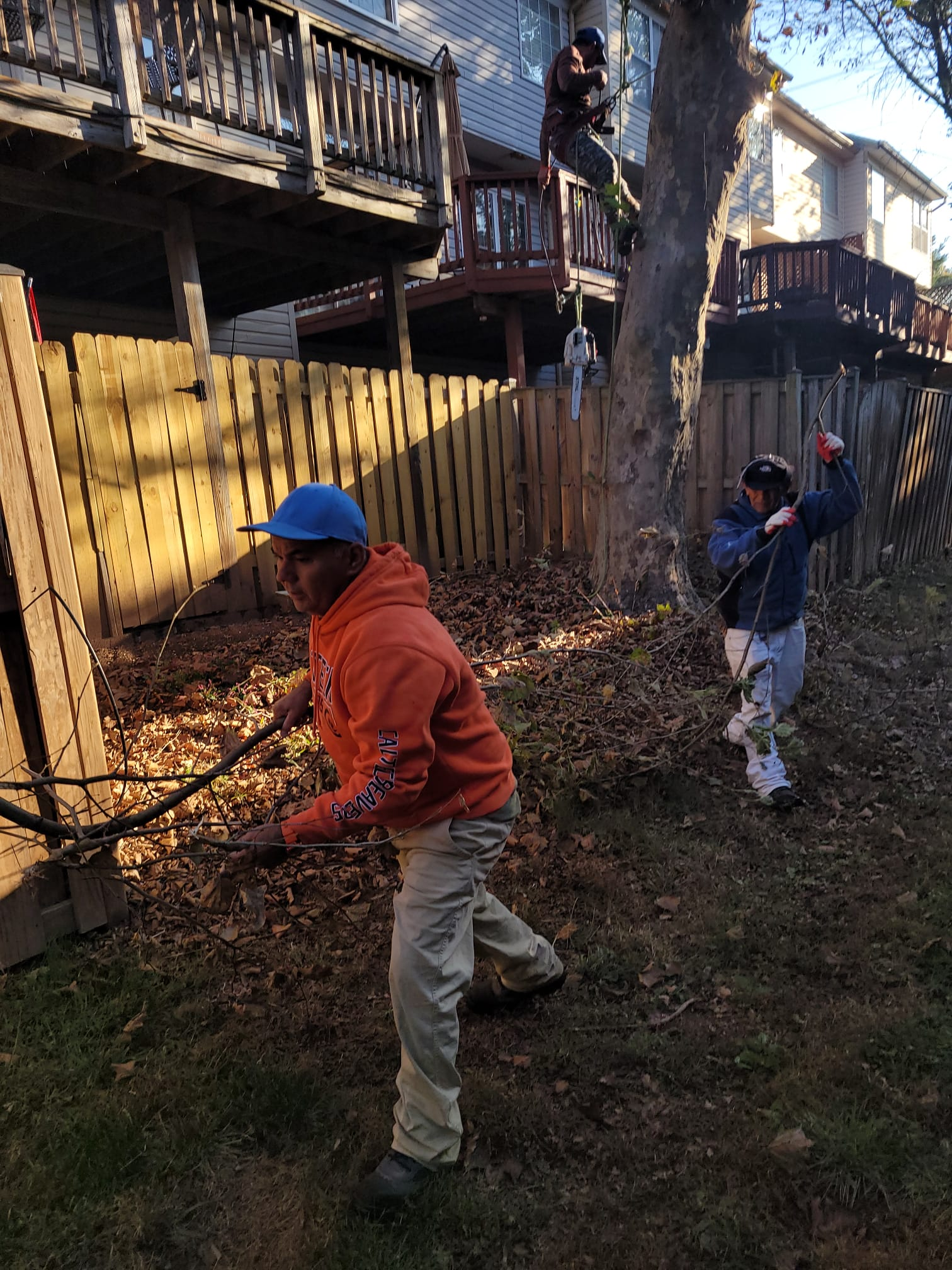 A man and a child are playing in a yard in front of a house.
