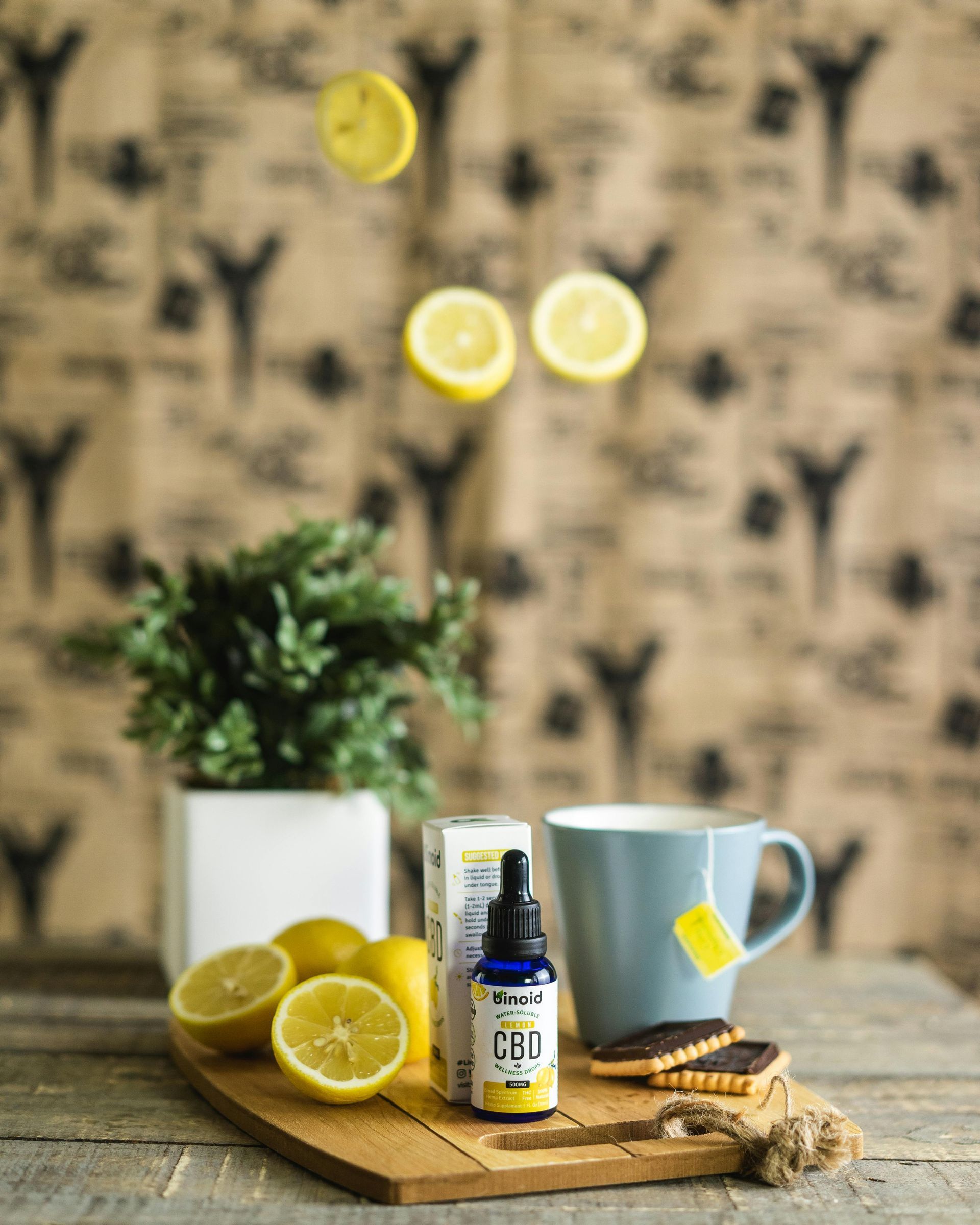 A cutting board with lemons and a cup of coffee on it.