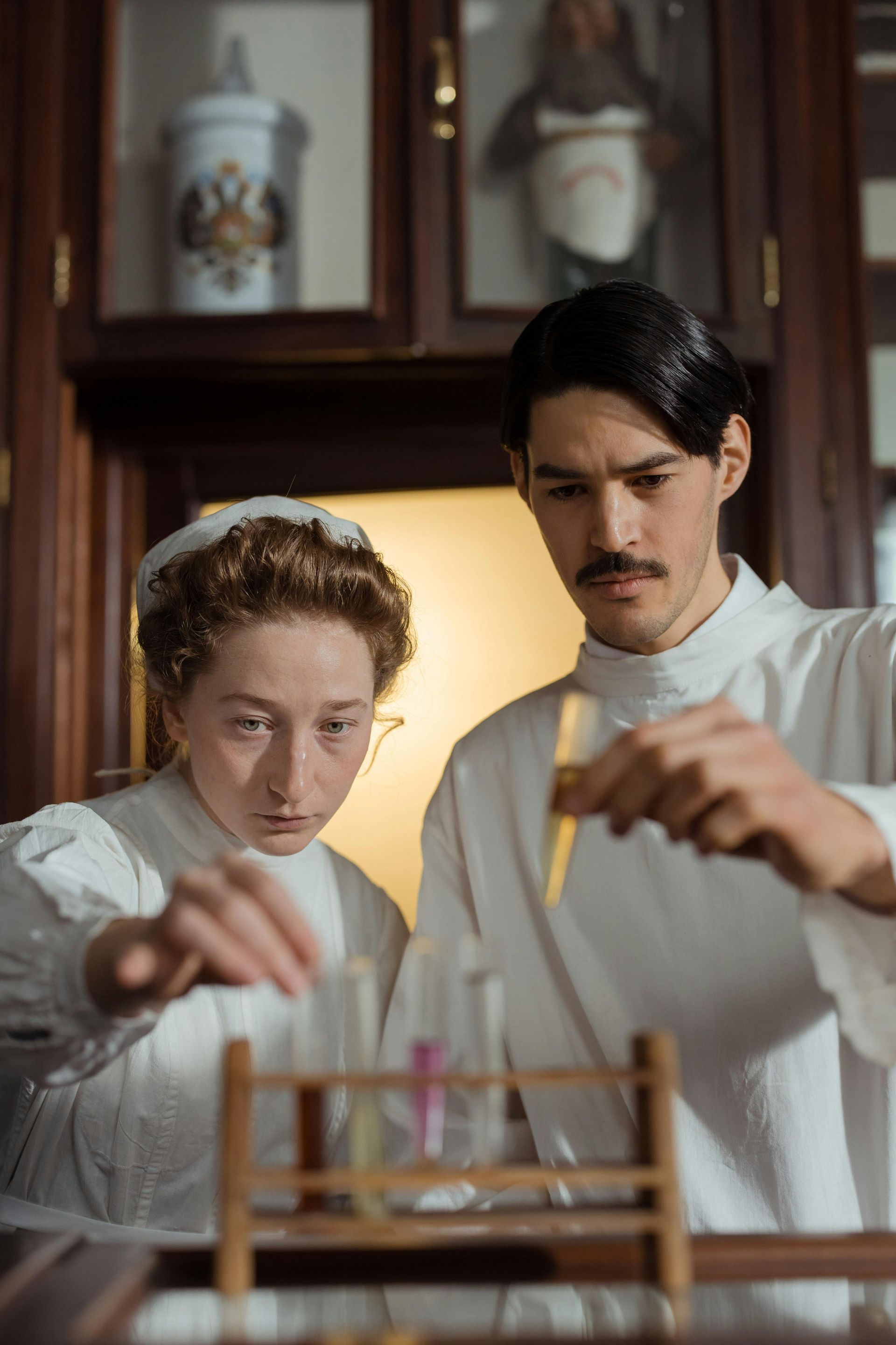 A man and a woman are working in a laboratory.