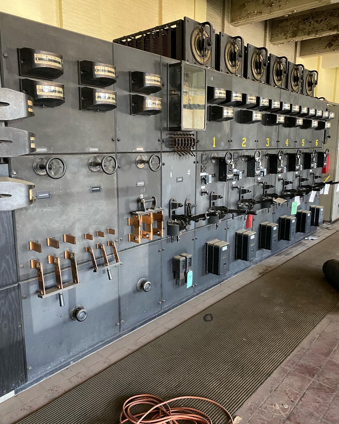 Gray electrical switchgear panel in an industrial setting.