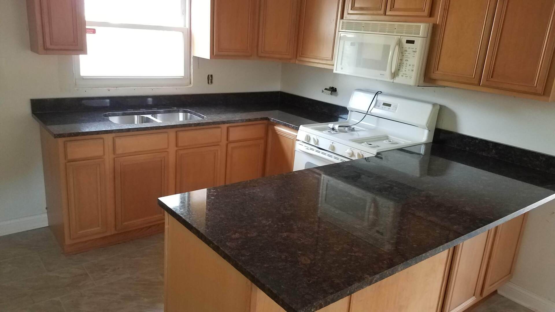 Granite kitchen countertop with wood cabinets