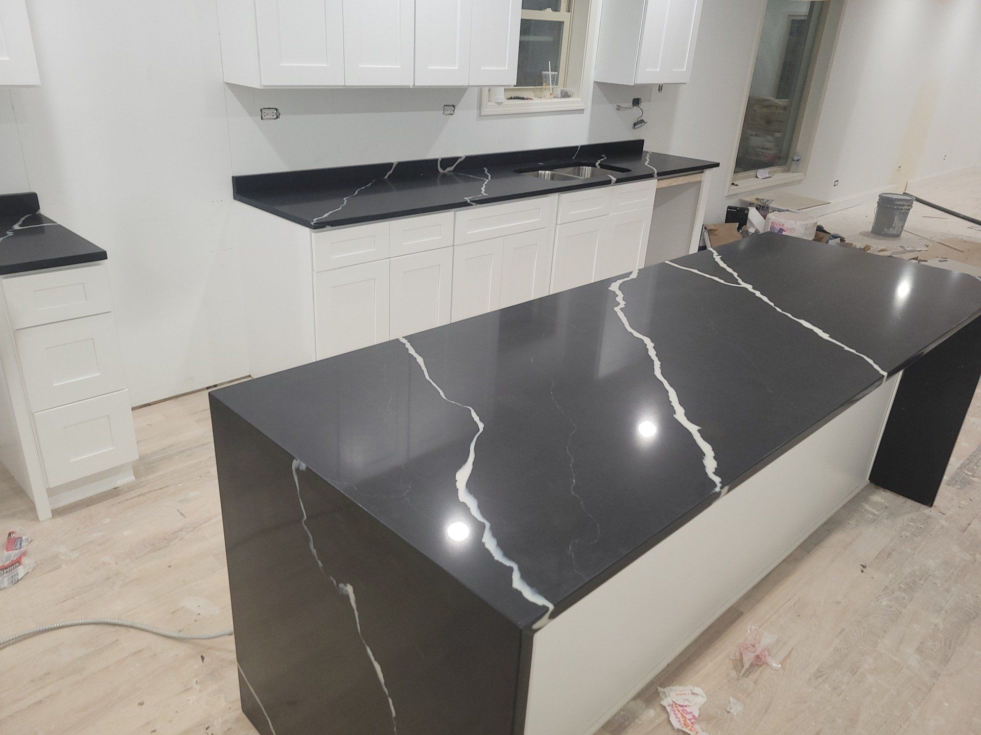 Marble countertops next to marble island in a luxury apartment