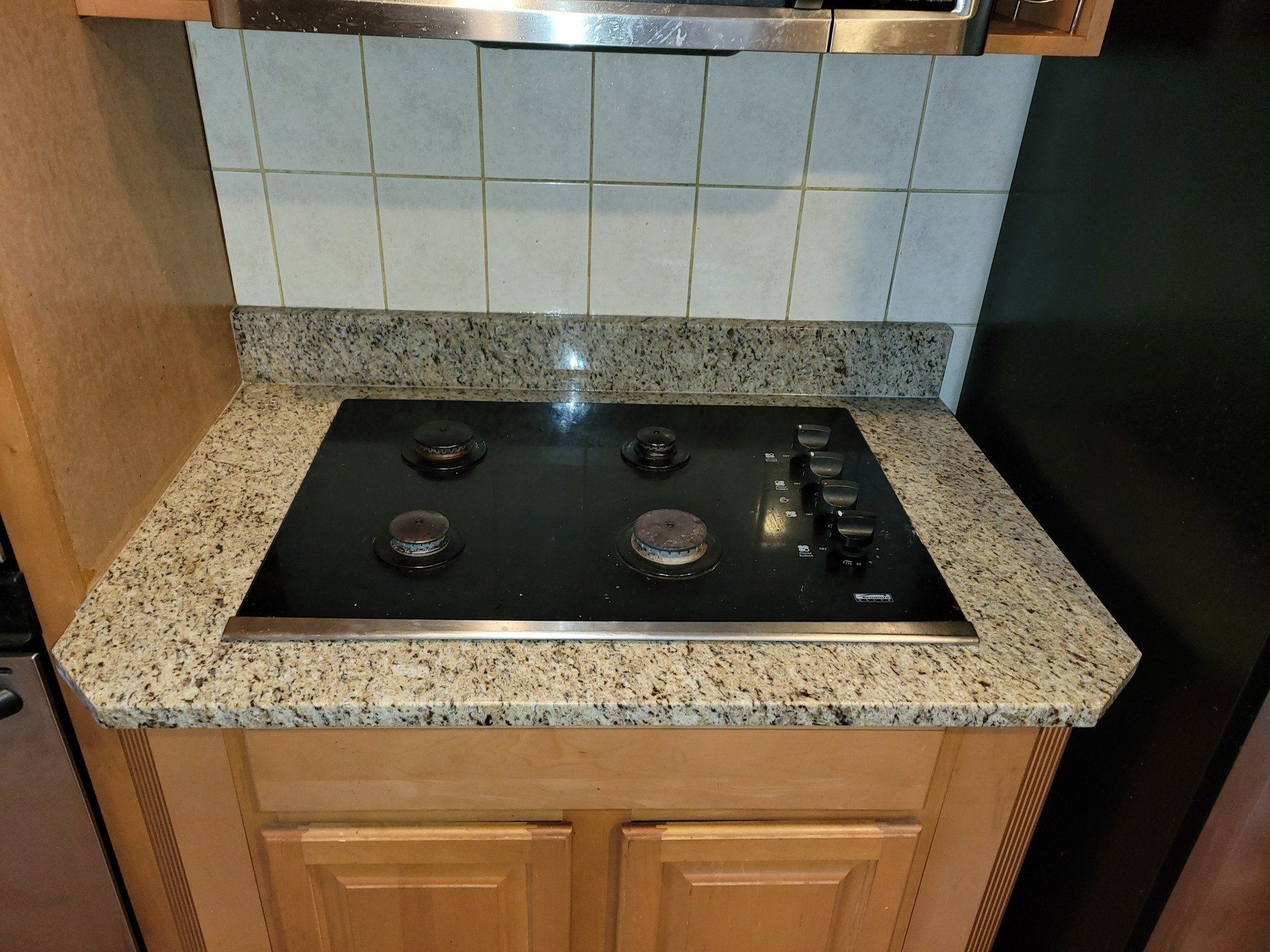 Granite kitchen countertop next to a stove top