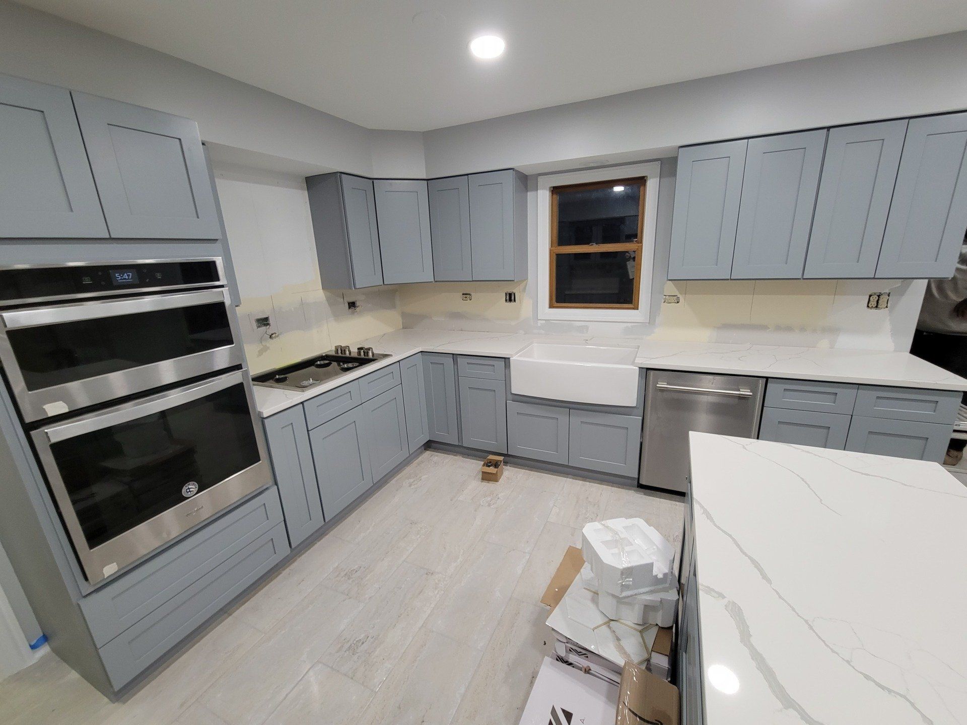 Marble countertop next to sink and dish washer in a kitchen