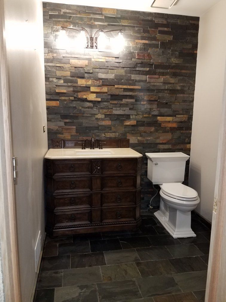 Marble bathroom sink countertop next to toilet