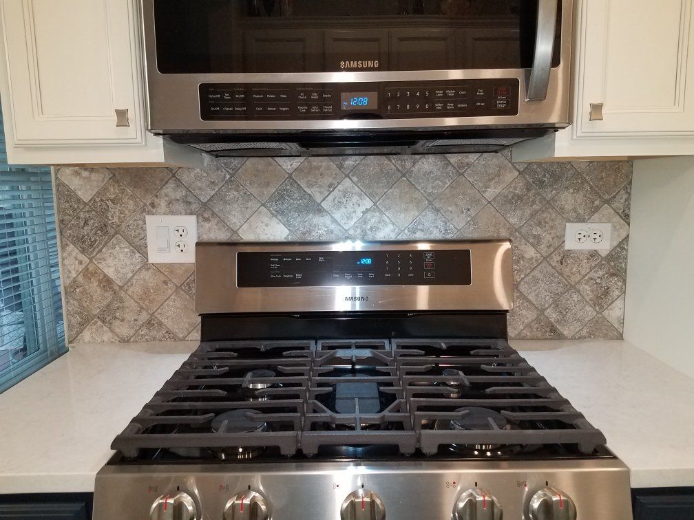 Marble kitchen countertop next to oven and stove top
