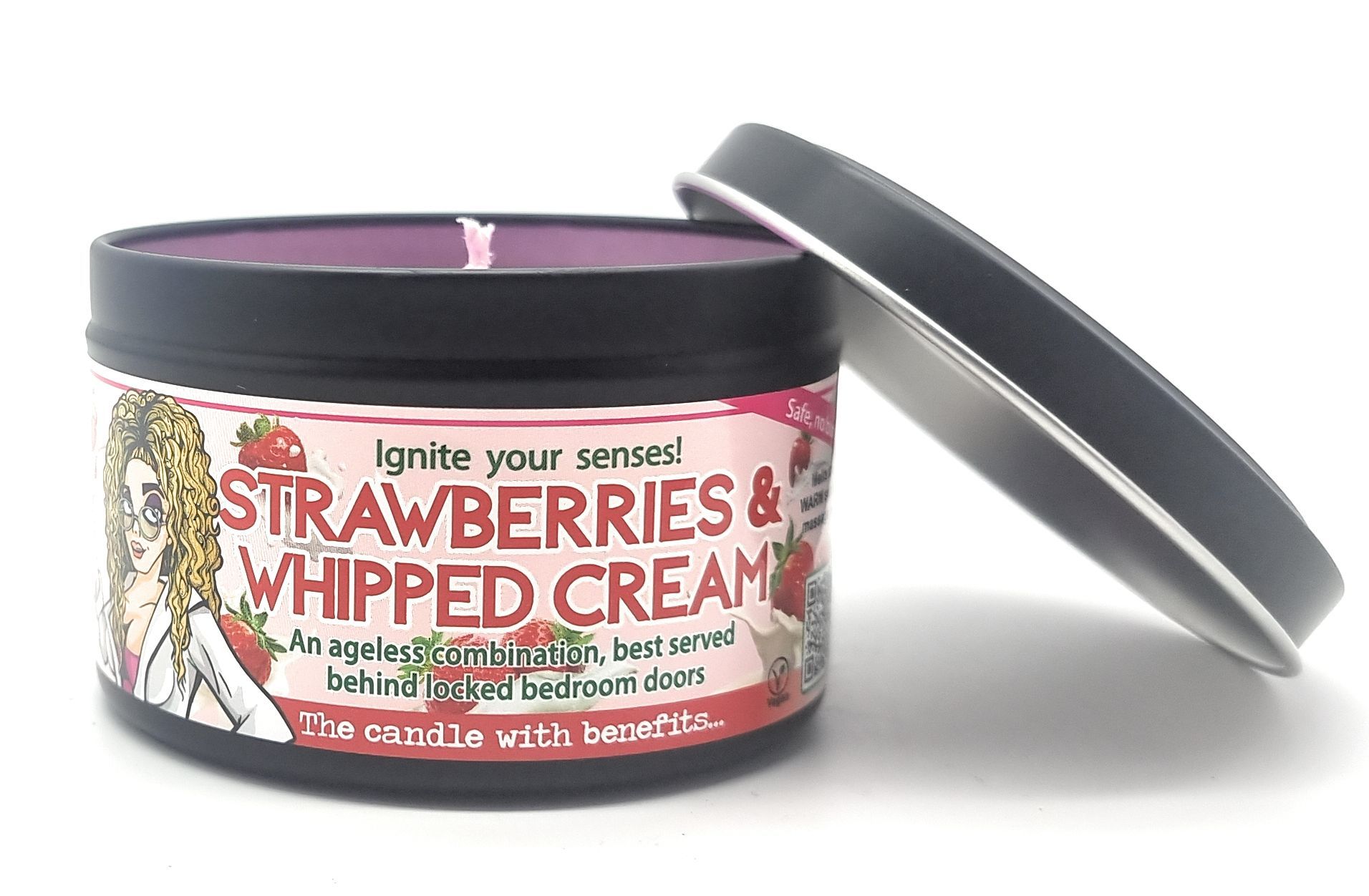 A black tin candle with a lid, labeled 