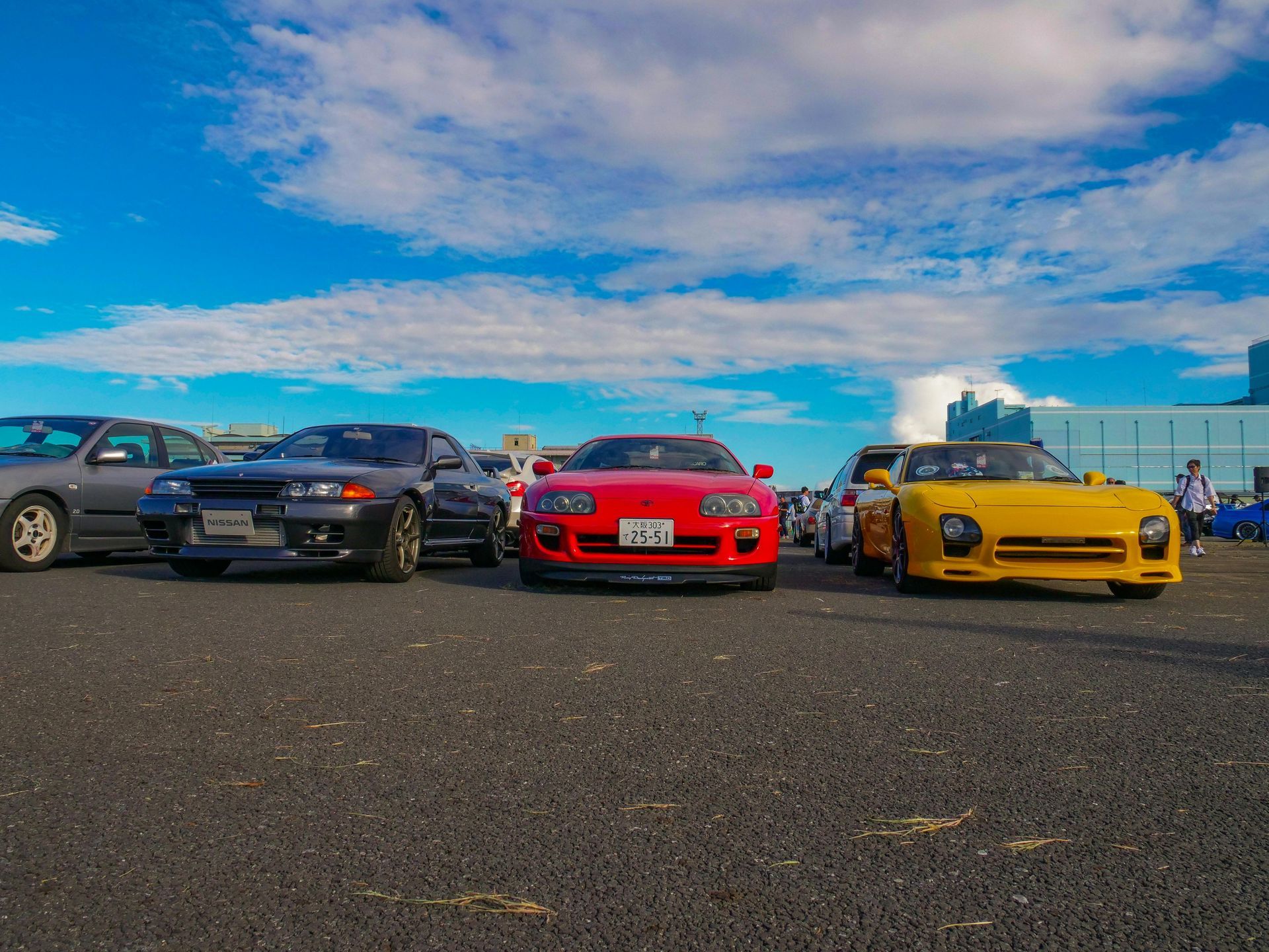 A group of cars are parked in a parking lot.