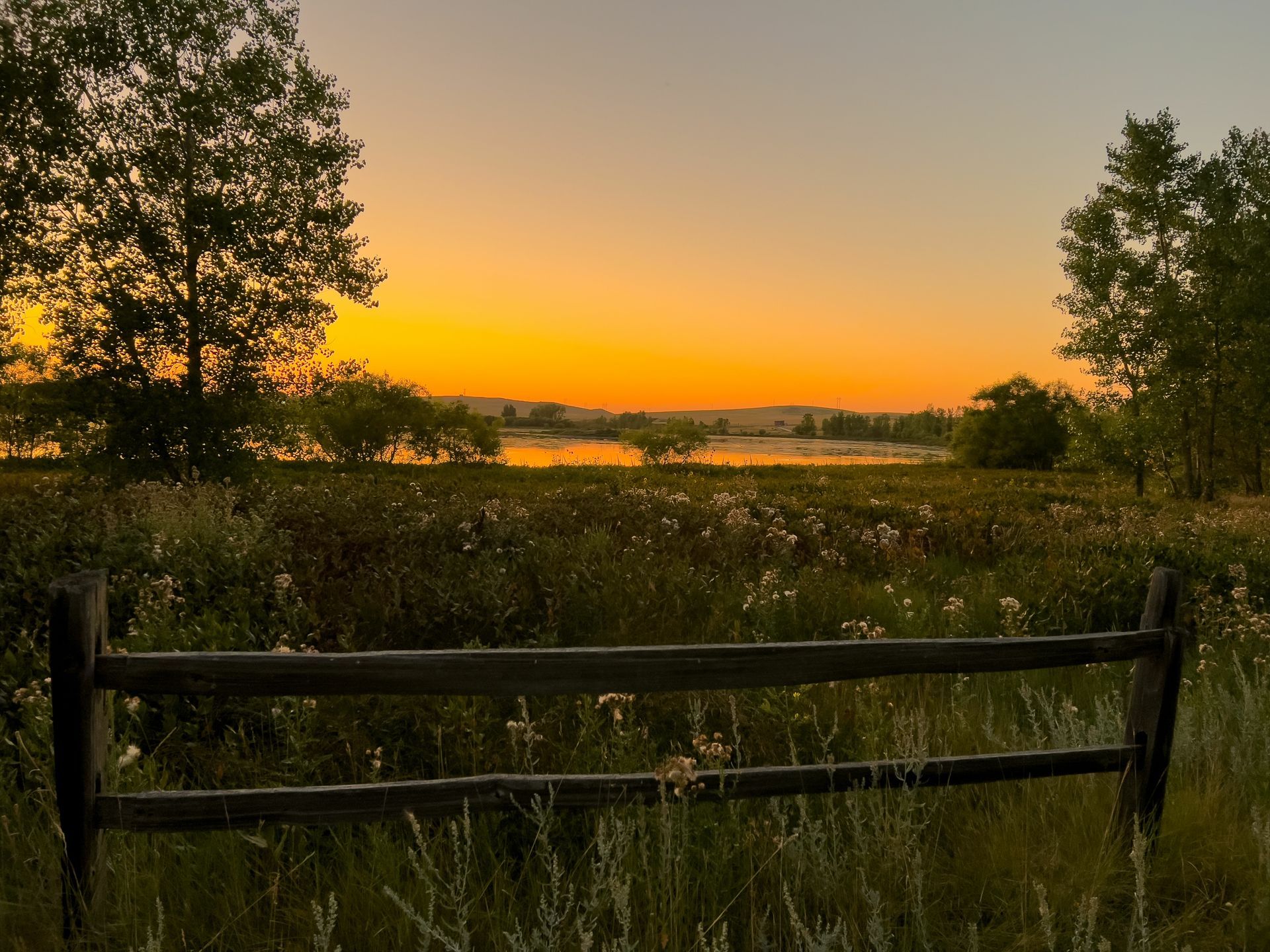 A sunset over a mountain range with a lot of fog