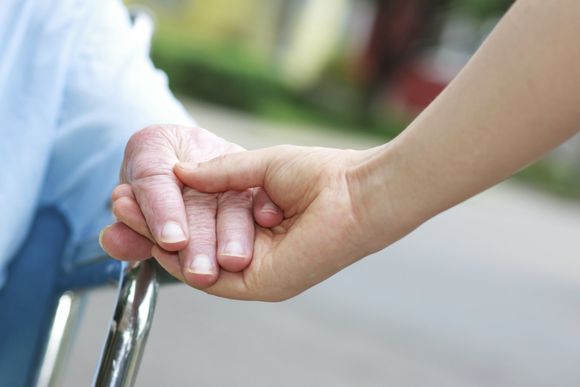 Holding elderly's hand — Liberty, MO — Assured Healthcare