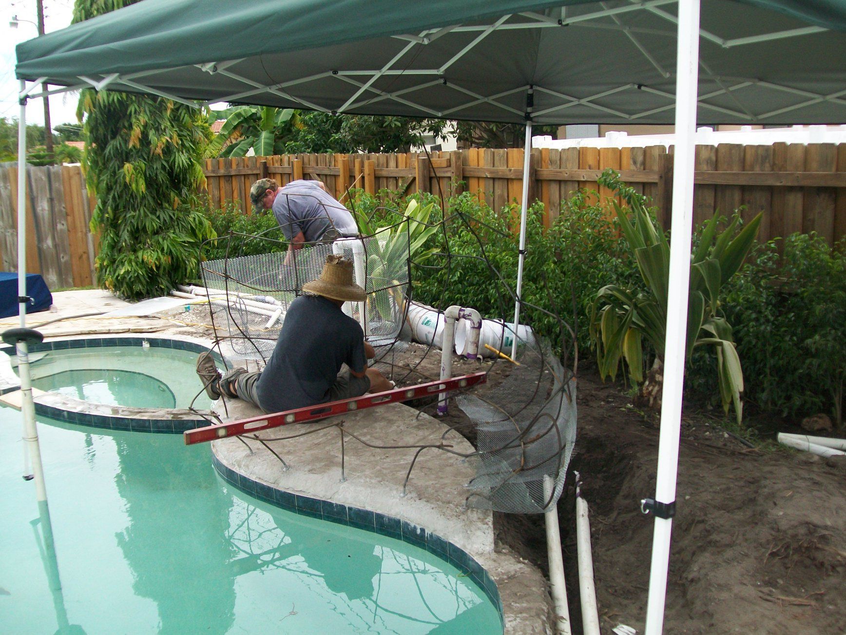 Open irrigation valve box in grass with gardening shears and pruners.
