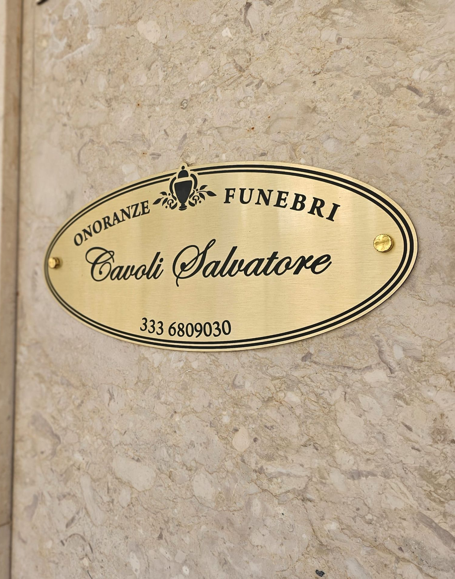 Gold plaque on a marble wall reads 