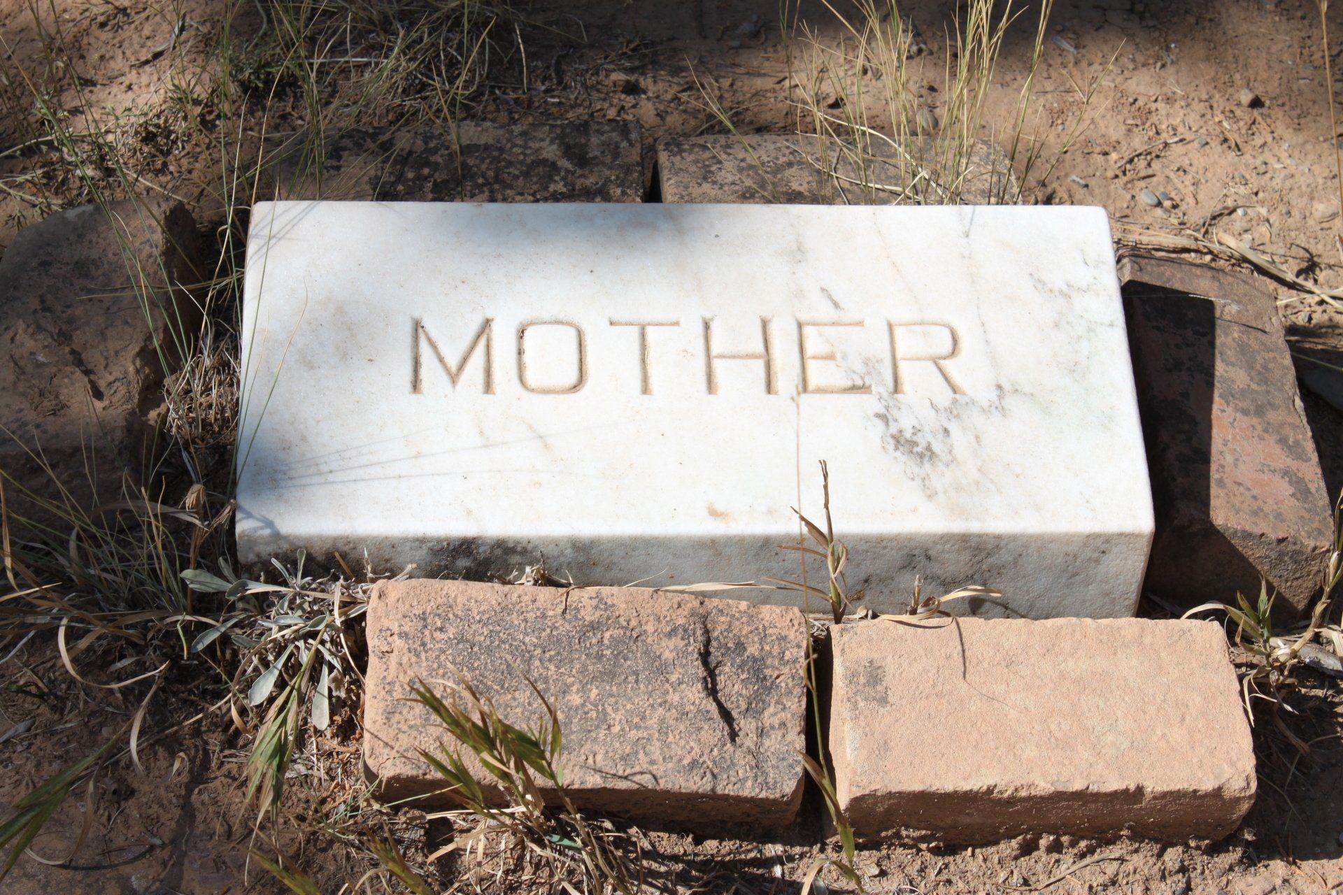 white tombstone into ground word mother