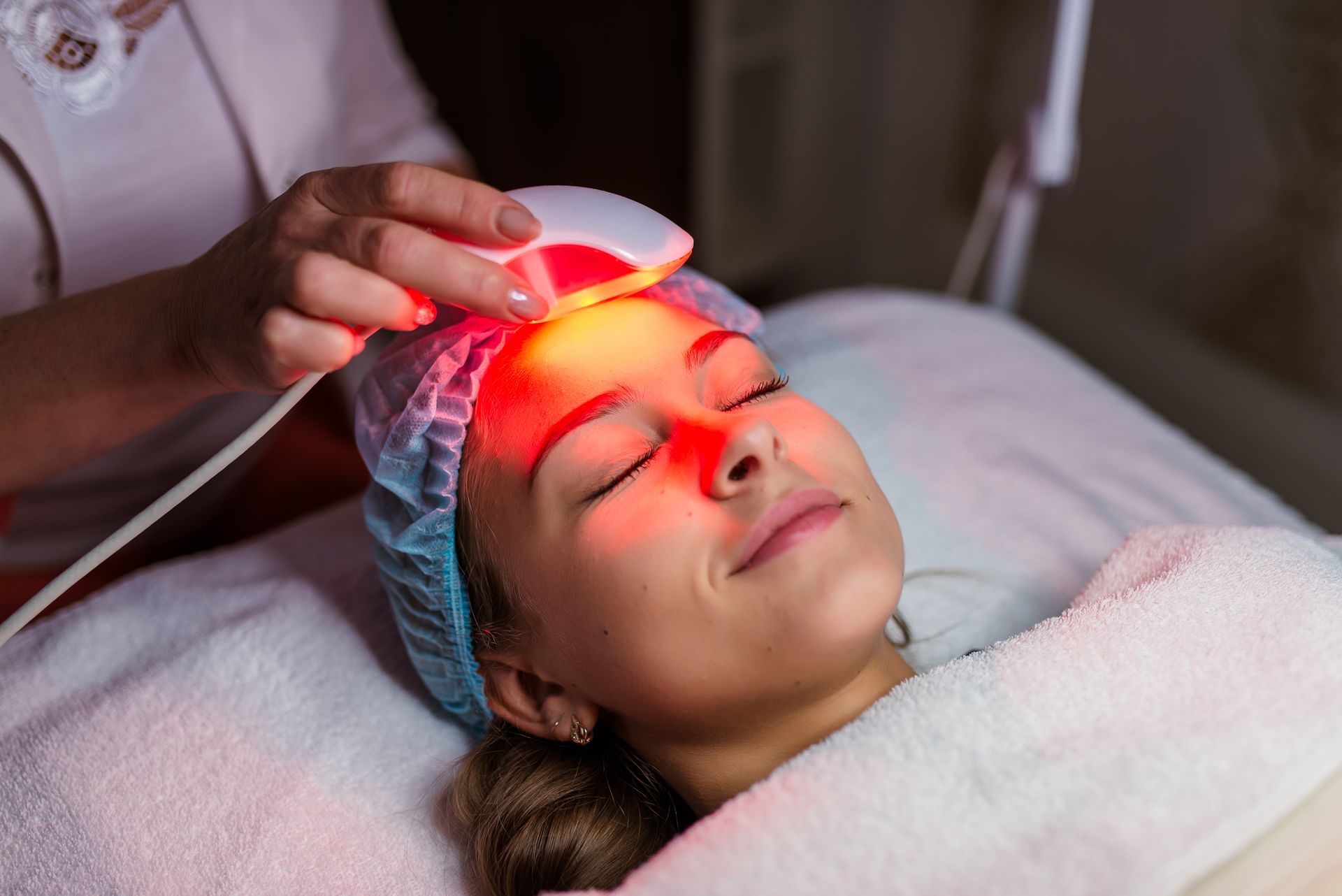 woman receives skin tightening laser treatment