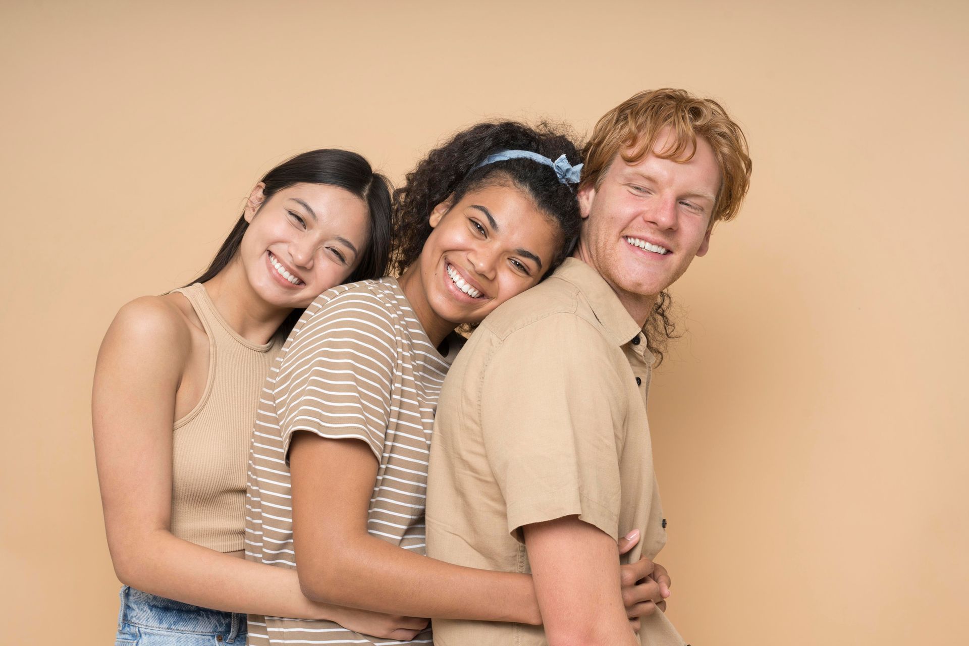 a man and two women are hugging each other and smiling