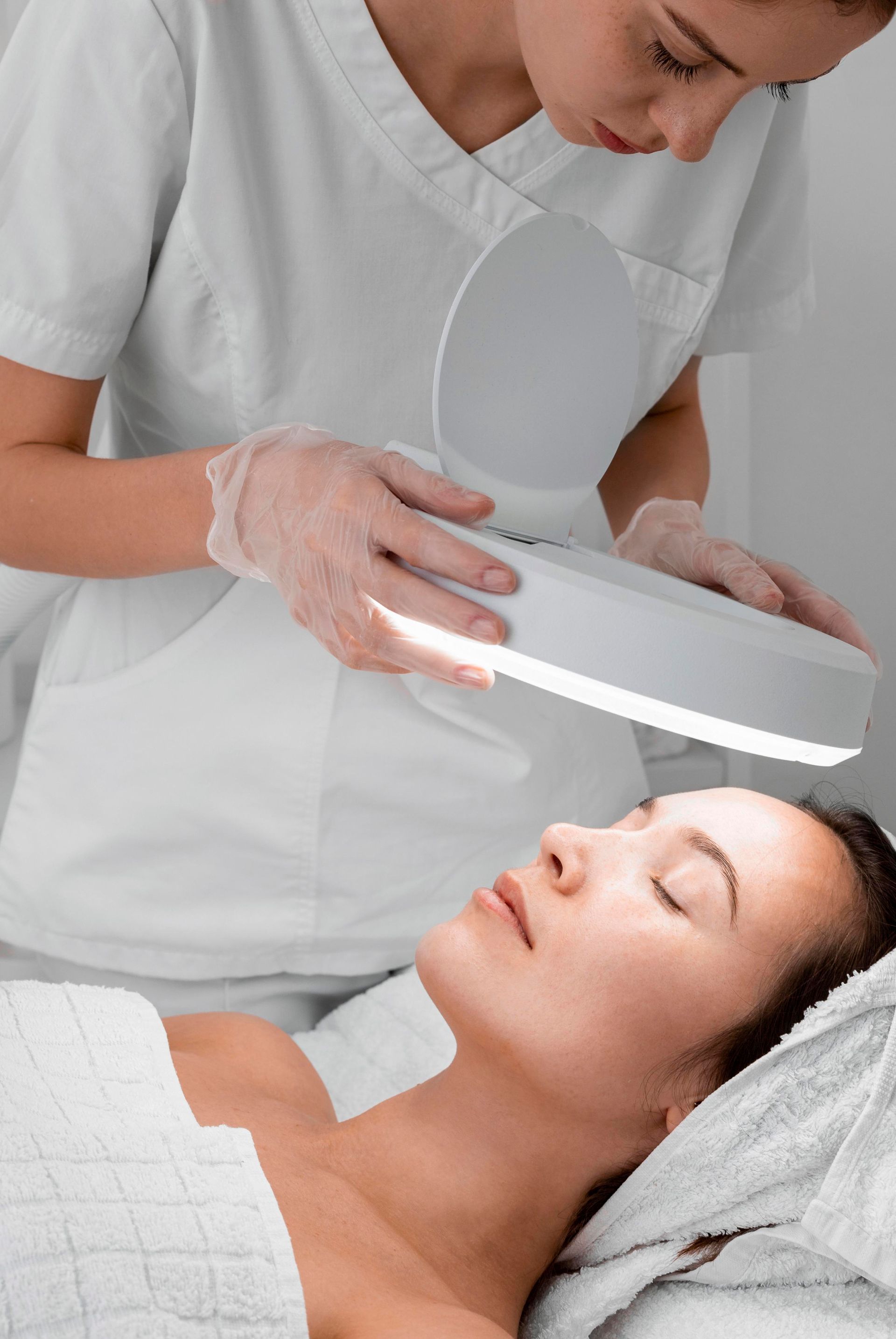 woman receives acne laser treatment