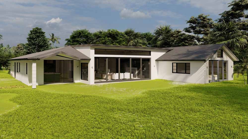 A white house with a black roof is sitting on top of a lush green field.