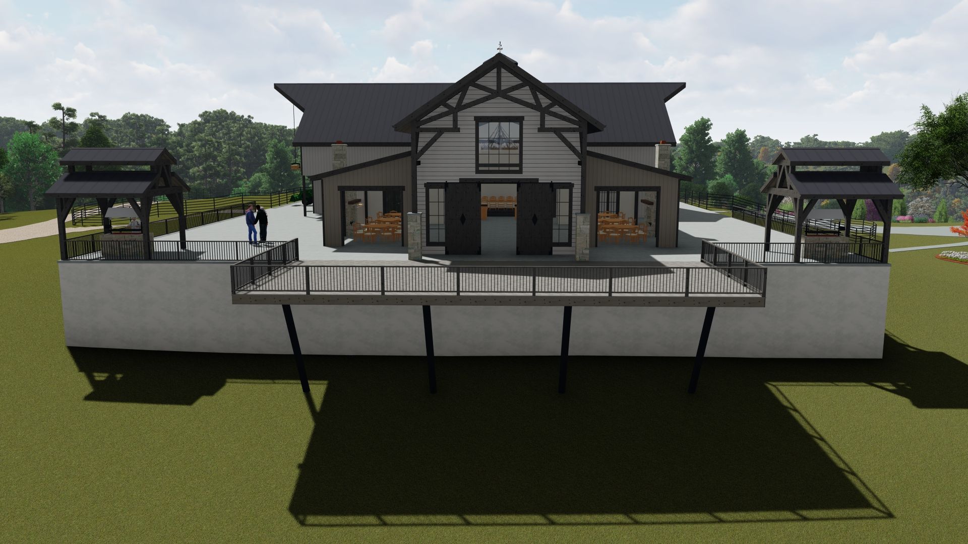 Modern building with a raised deck and two small gazebos, set against a green lawn and trees.