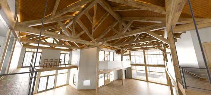 A large empty room with a wooden ceiling and lots of windows.