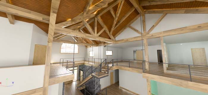 A large empty room with wooden beams and a spiral staircase.