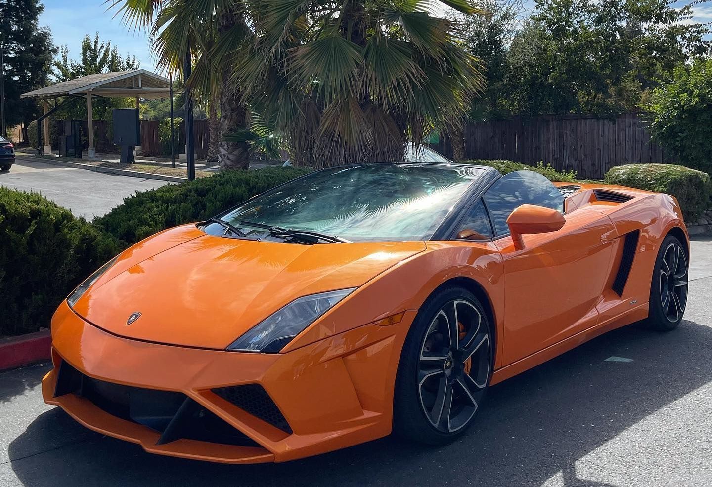 Orange Lamborghini Gallardo Spyder convertible parked outdoors.