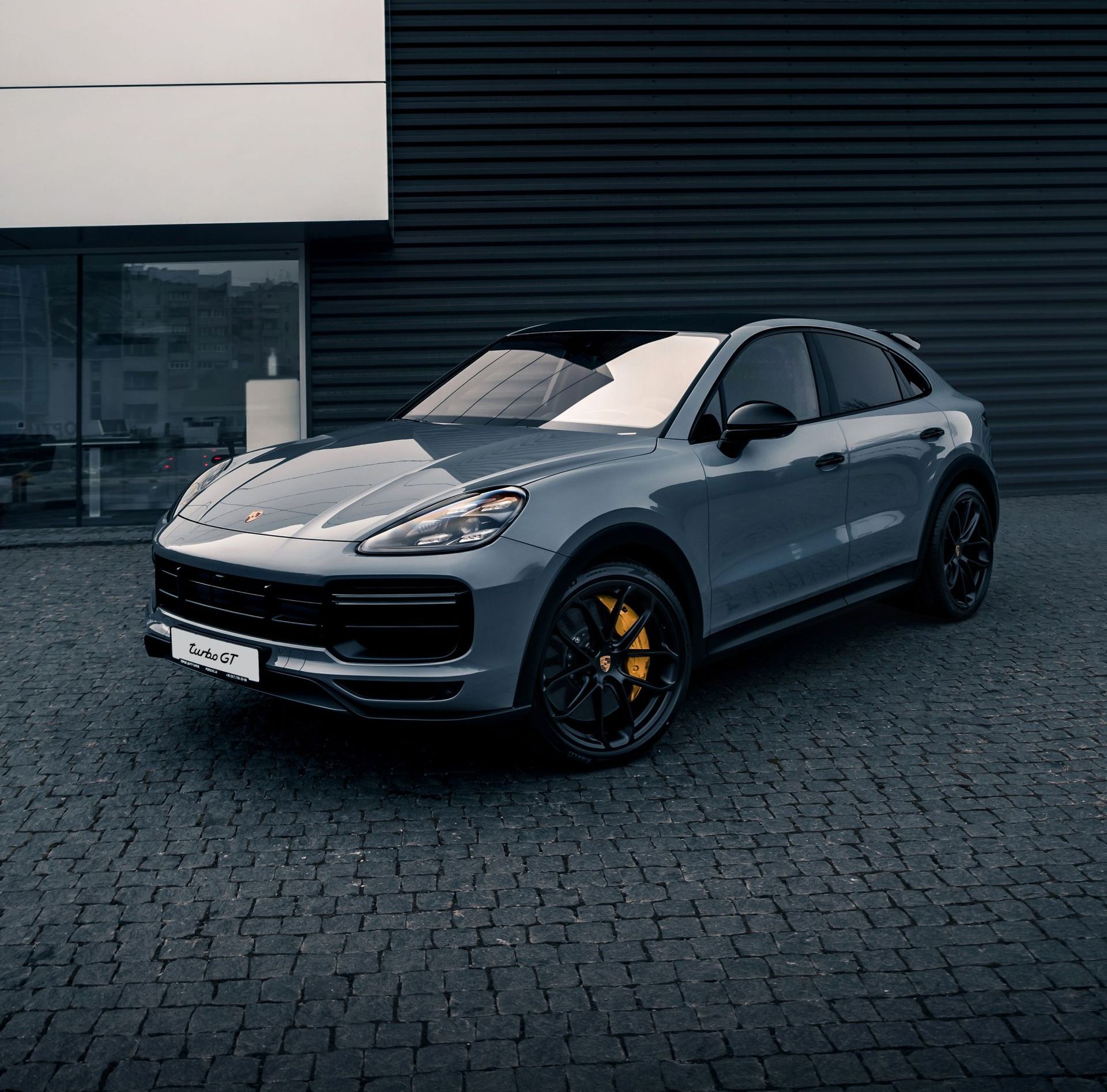 A black mercedes benz s63 amg is parked in a showroom.