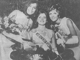 Three smiling pageant winners posing with bouquets, the center wearing a sash.