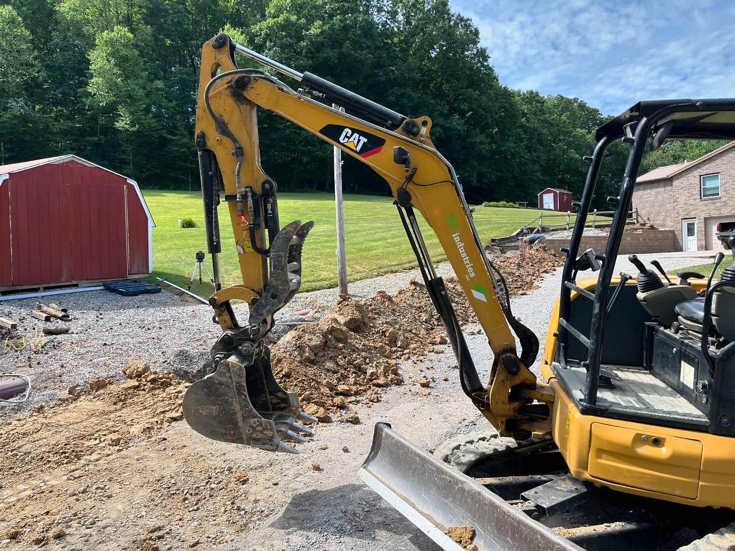 A yellow excavator is digging a hole in the dirt.