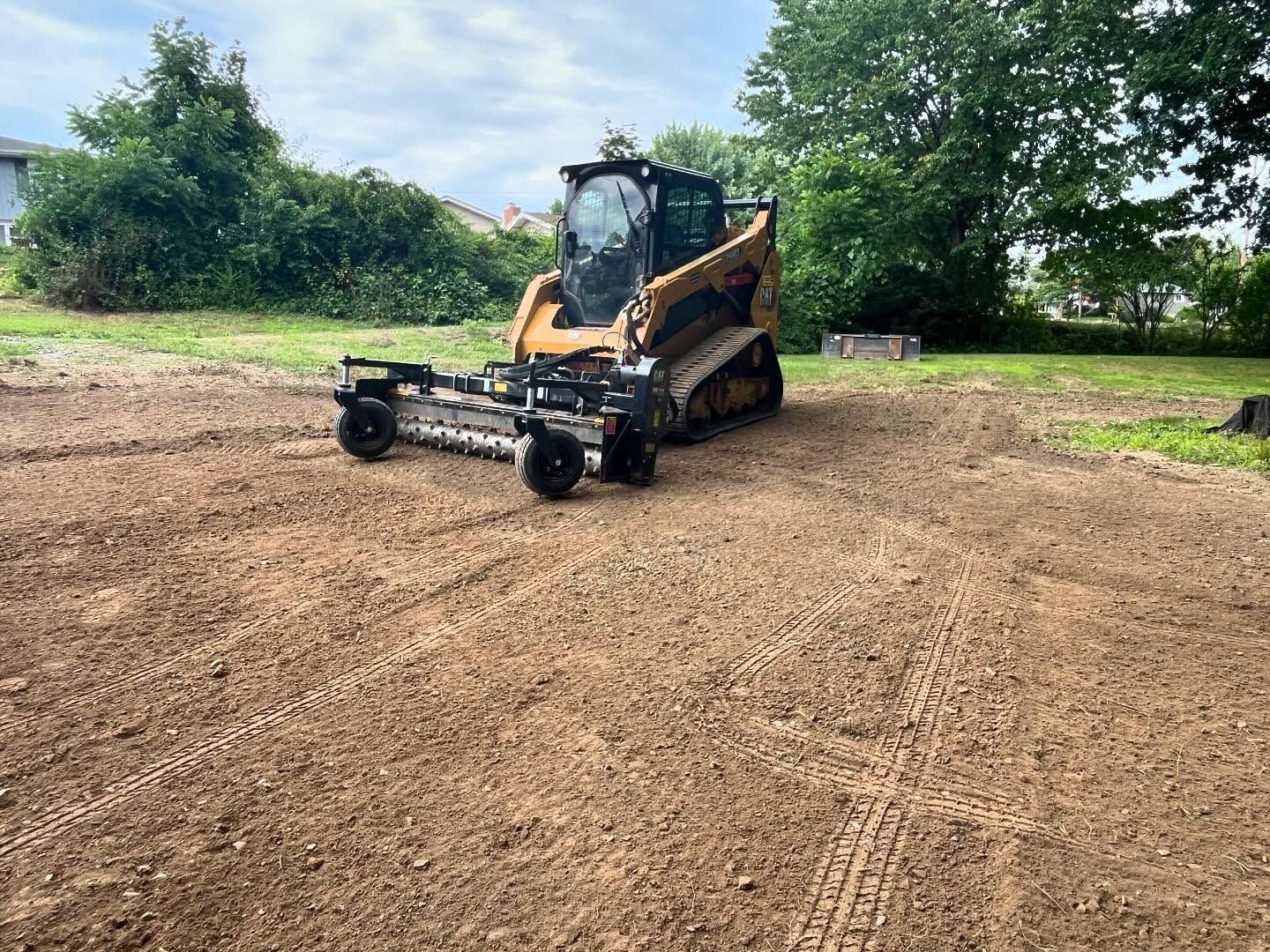 A bulldozer is sitting on top of a dirt field.