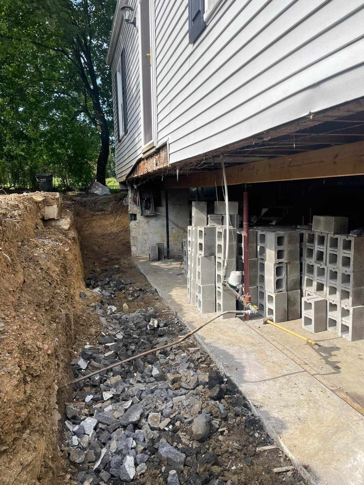 A house is being remodeled and a foundation is being built.