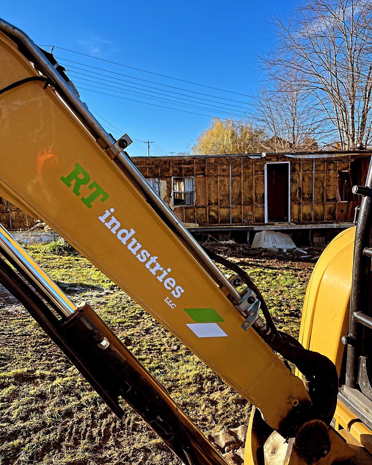 A yellow excavator with rt industries written on it