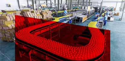 A factory production line with a red conveyor belt carrying bottles. Workers and stacks of boxes are also present.