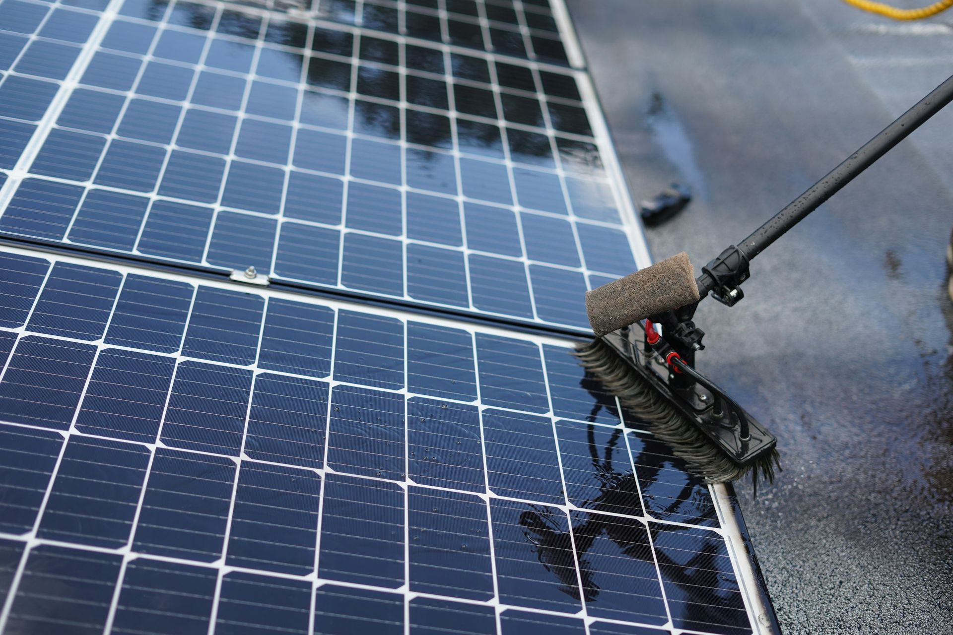 Solar panel cleaning using water fed pole