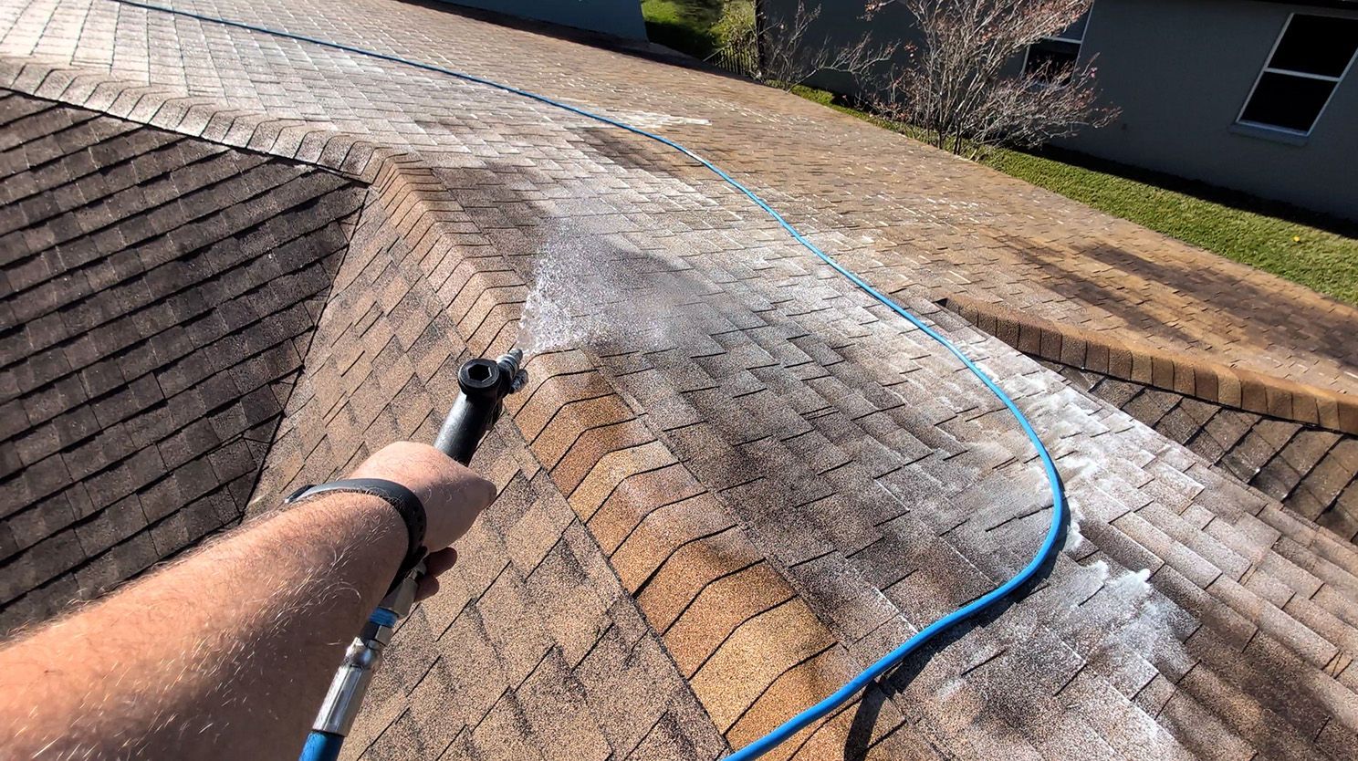 Roof soft washing in progress