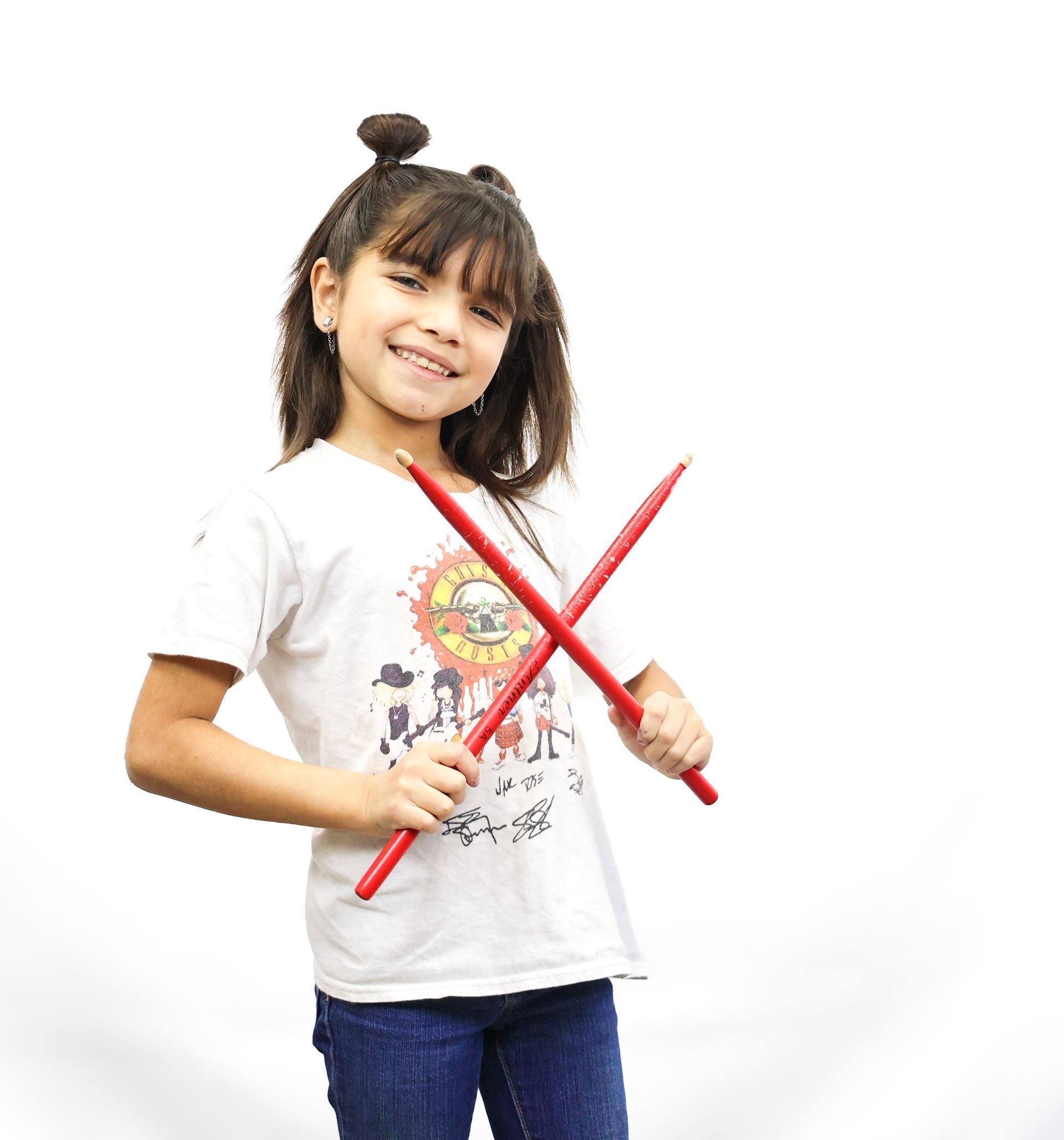A young man is playing drums in a room.