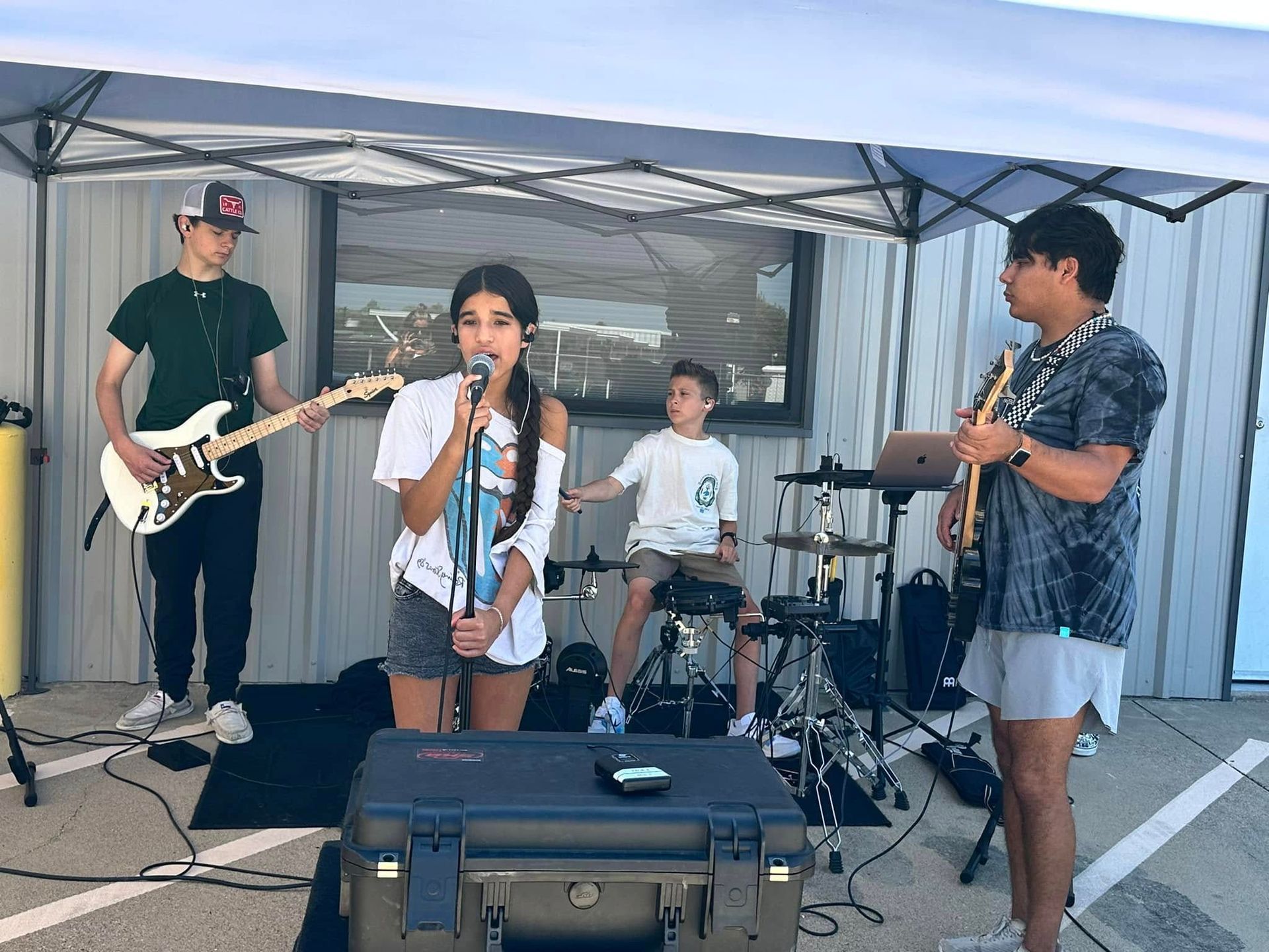 A group of people are standing on a stage in front of a crowd.