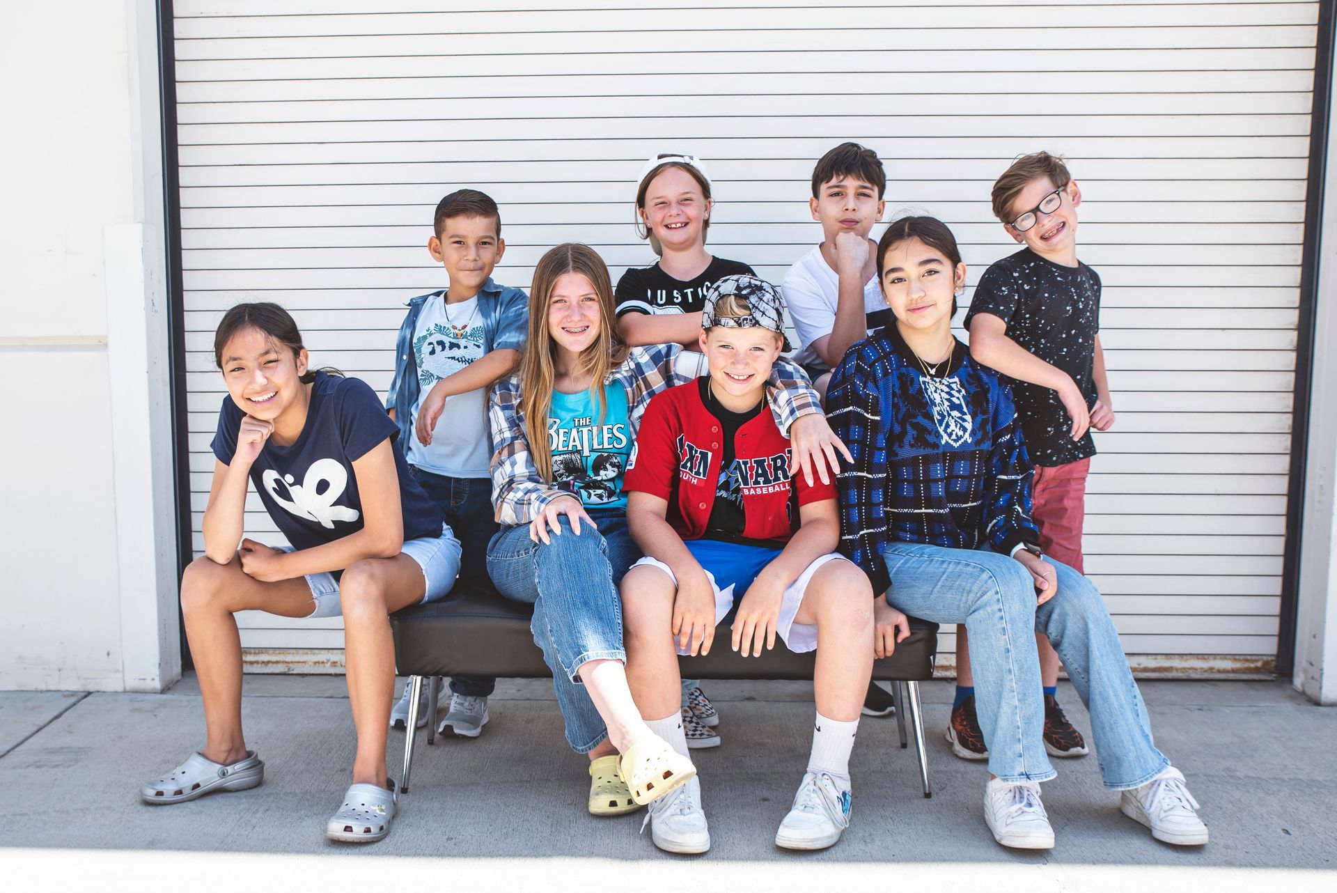 A group of young girls are standing next to each other in a room.