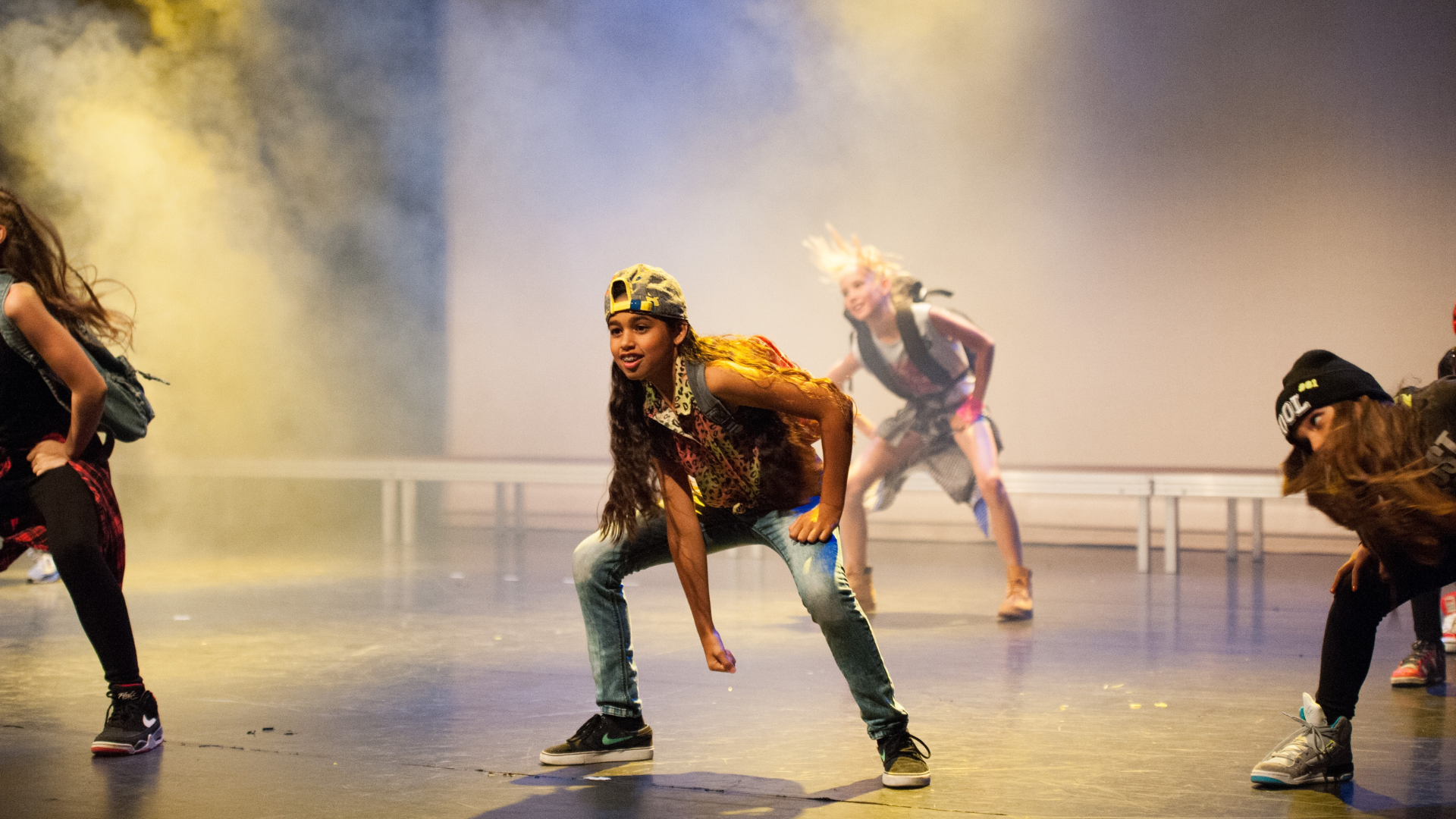 A group of people are dancing and singing on a stage.