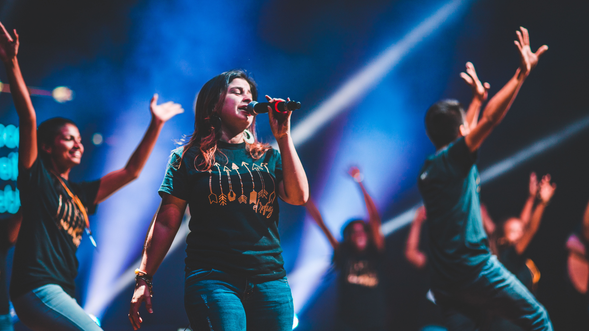 A group of people are dancing and singing on a stage.