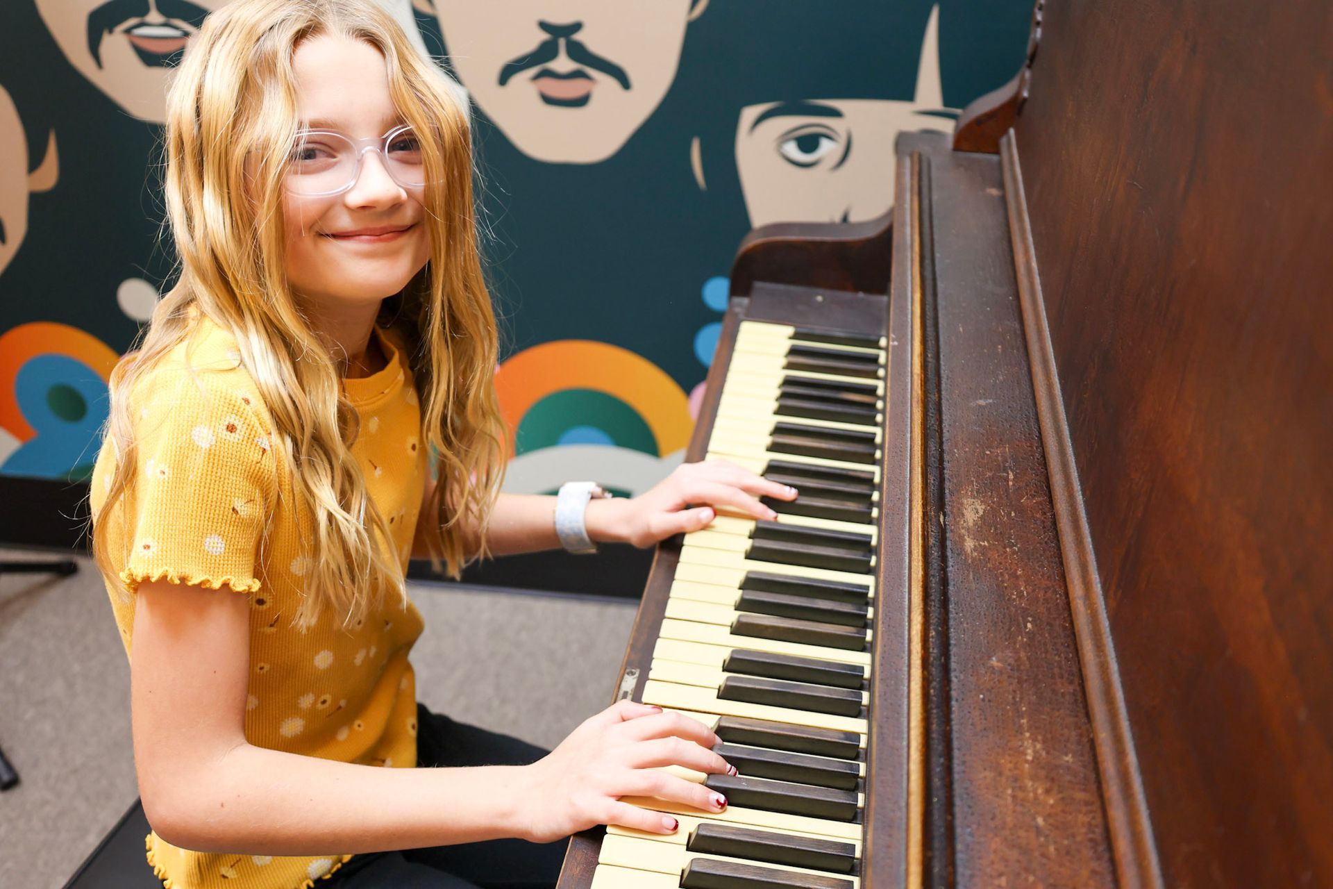 A girl in a red dress is singing into a microphone