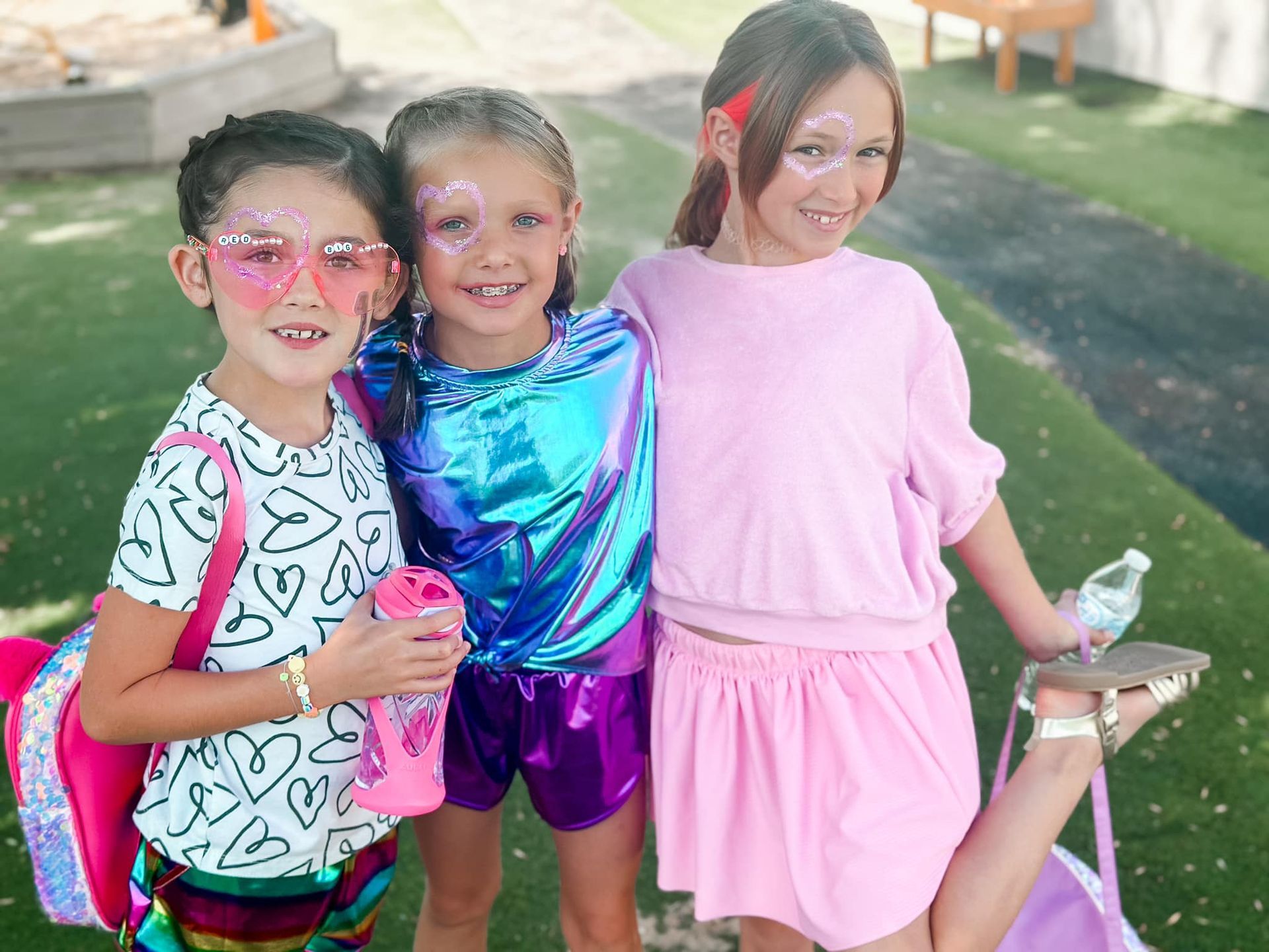 A young boy is sitting at a keyboard and smiling.
